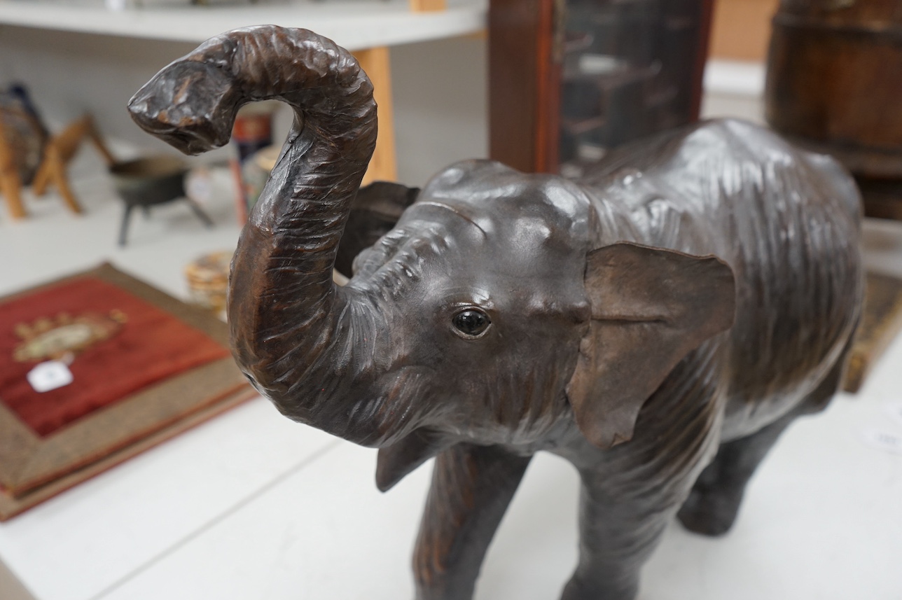 A large Liberty style leather elephant, 64cm wide. Condition - fair, minor repairs